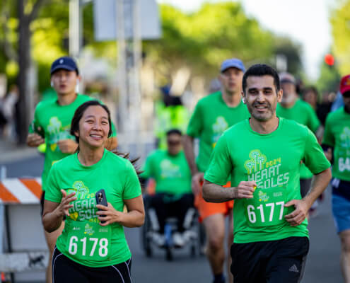 Two smiling Heart & Soles runners